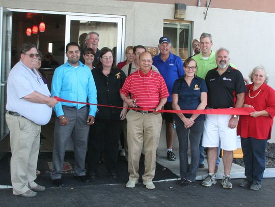 New Super 8 owners celebrate ribbon cutting