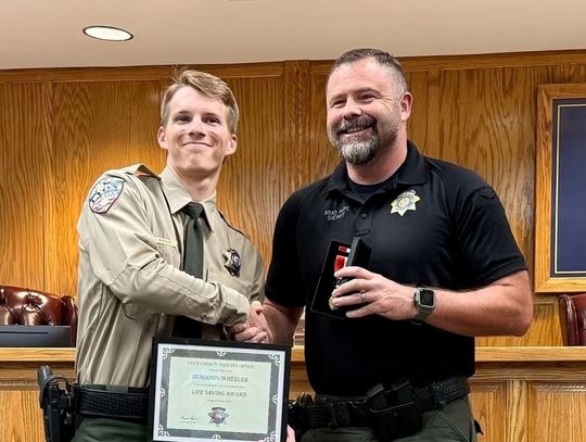 Deputy Benjamin Wheeler received an award from Sheriff Brad Pope.