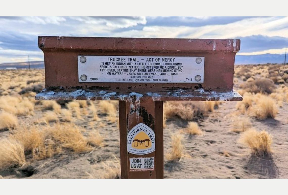 Trail West of Mercy historical marker in the desert.